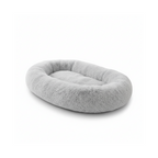 Soft gray oval plush pet bed for dogs and cats on white background