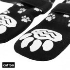 Black cotton pet socks with white paw print grips and adjustable straps for dogs or cats