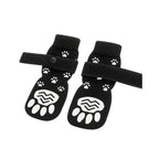 Black non-slip dog socks with paw print grip and adjustable straps