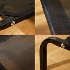 Close-up of elevated breathable mesh pet bed frame with black metal legs on wood floor