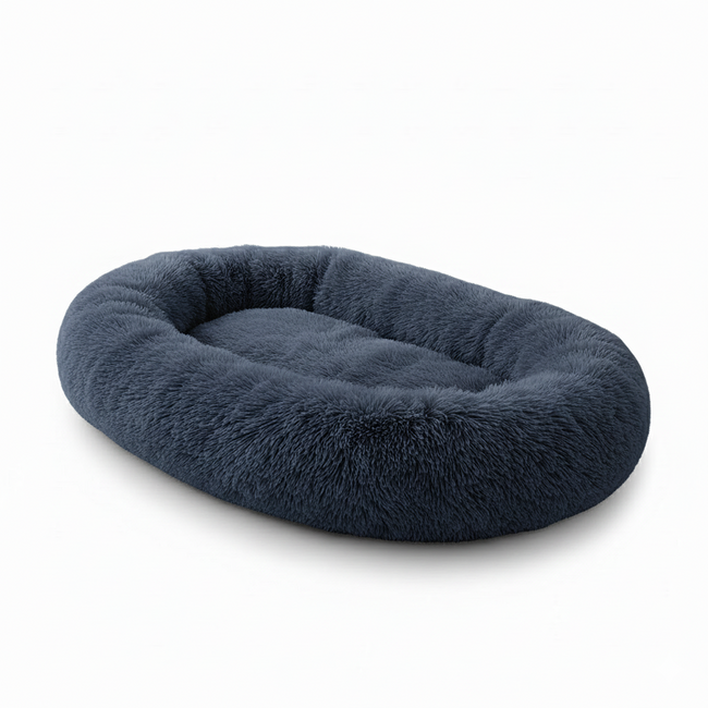 Plush oval navy blue pet bed with raised edges on white background Hover Image