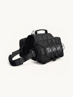 Black tactical dog hiking pack with MOLLE system, durable dog pack for outdoor adventures and hiking trips.