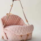 The cozy dog car seat used as a comfortable temporary bed for a resting pet during an outdoor picnic.