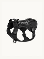 Isolated black tactical dog harness with reflective stitching, a no-pull easy walk dog harness with multiple D-rings for leash attachments.