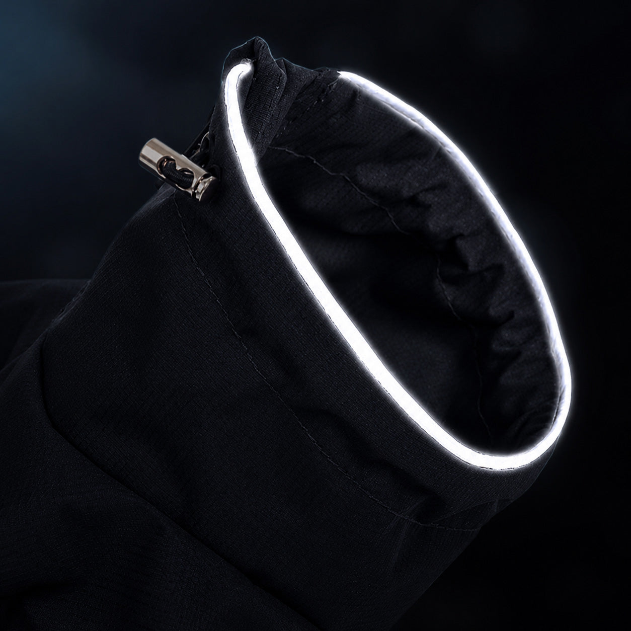 Black dog jacket collar opening with a glowing full-circle reflective trim on dark background, highlighting night safety visibility design.
