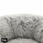 Close-up of soft, fluffy grey pet bed made of polyester fabric, cozy and plush texture.