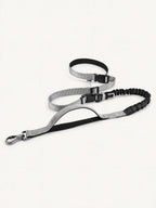 Multifunctional hands-free long dog leash with bungee shock absorption, adjustable waist belt, and reflective stitching for safe, comfortable walking and running.