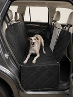 Whippet resting comfortably on a quilted waterproof dog car seat, a durable dog safety seat for car travel to protect your backseat.